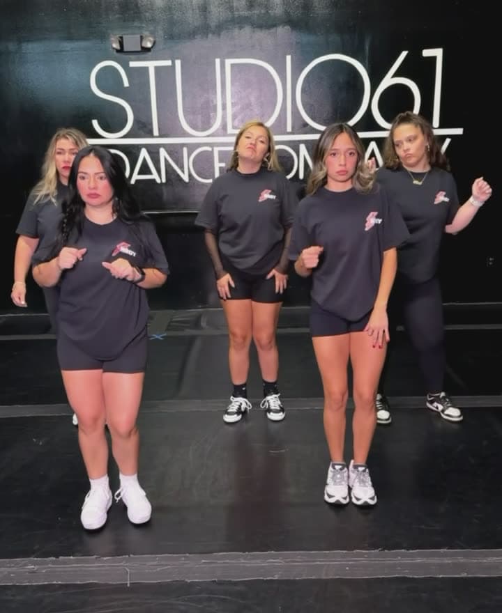 The coaches lined up in front of the studio wall
