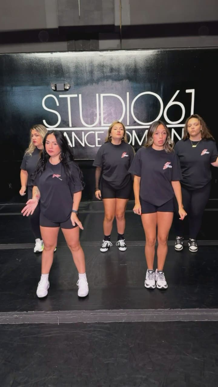 The crew lined up in front of the studio sign