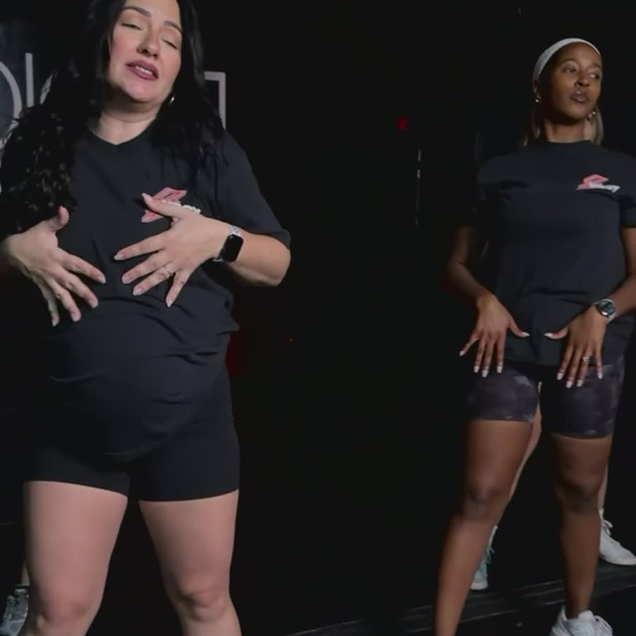 Nat and a coach dancing side by side