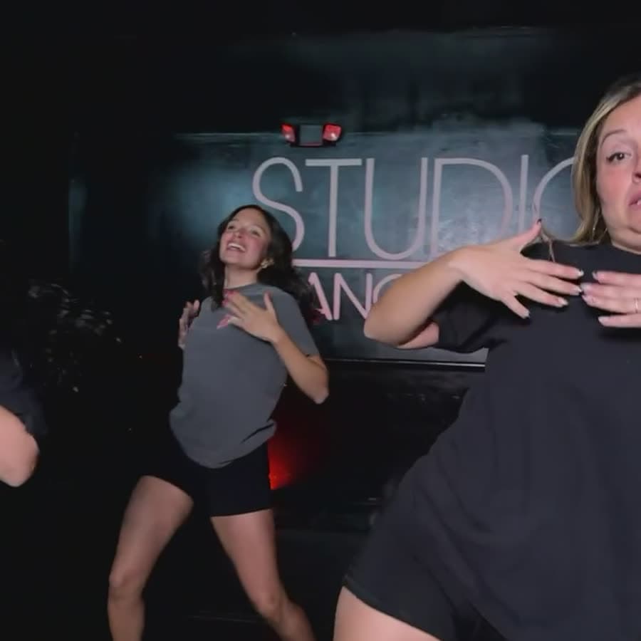 Two members dancing under the red lights