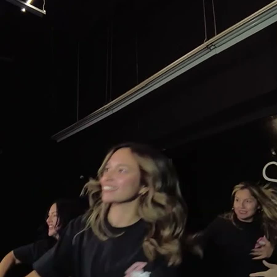 A member mid-move with the group behind her
